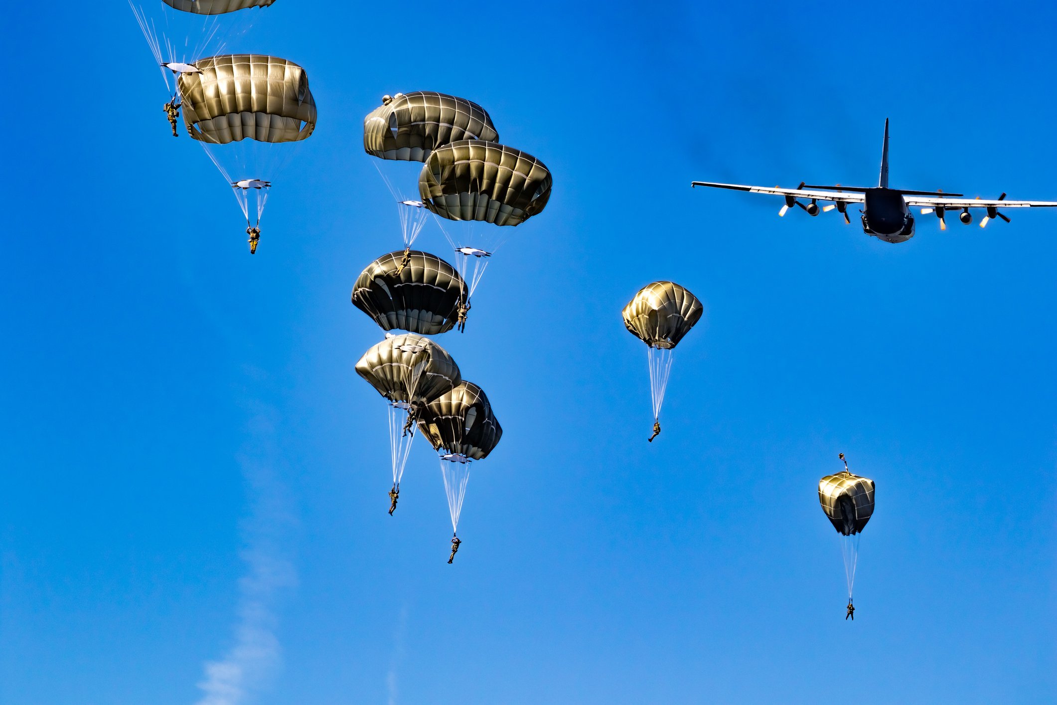 a number of parachutes leaving an airplane