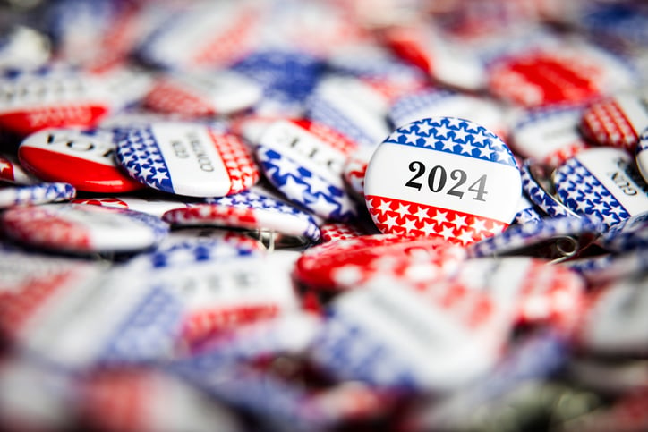 A pile of election and political buttons including one that reads 2024