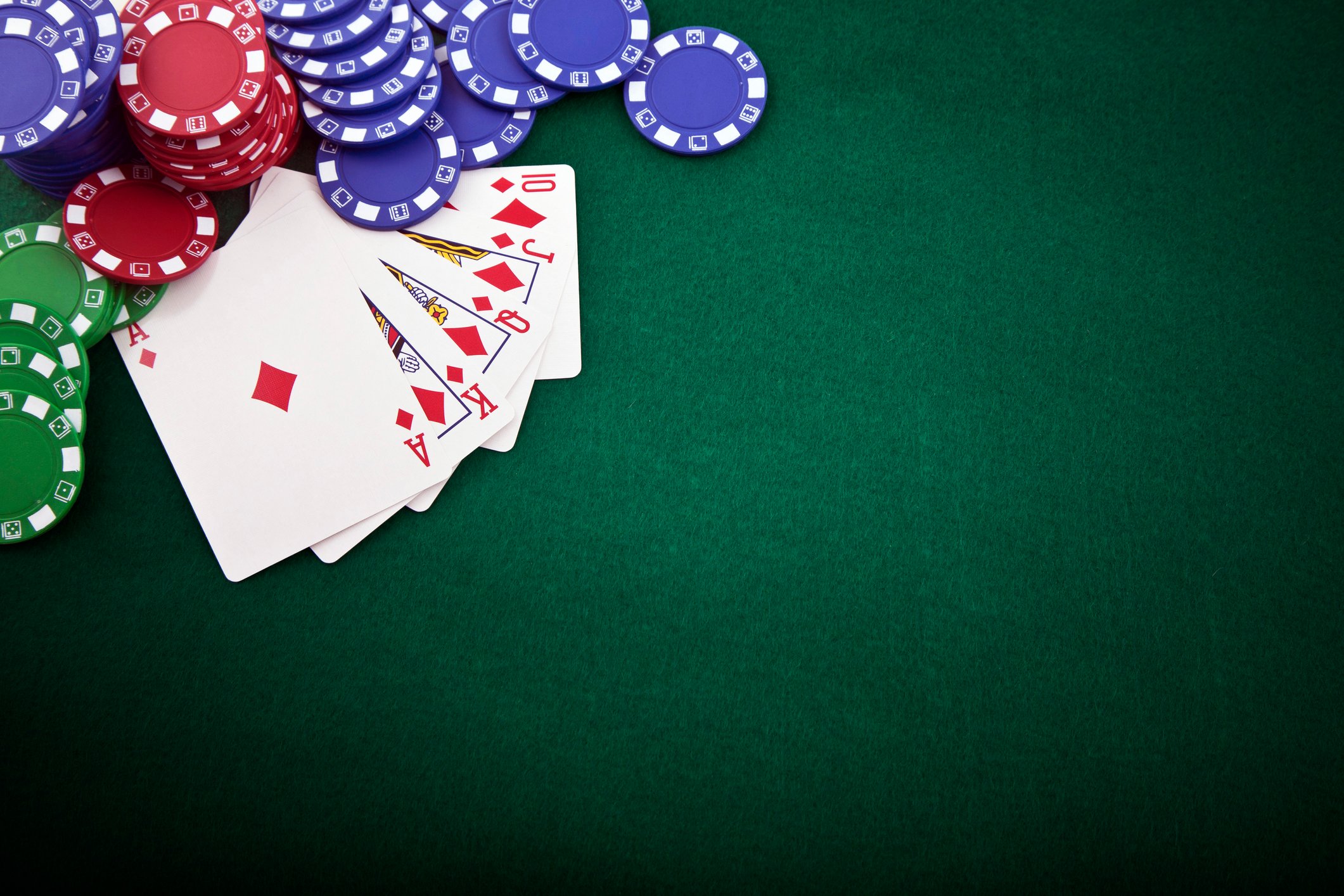 photo of a royal flush laid out on the poker table with chips scattered nearby