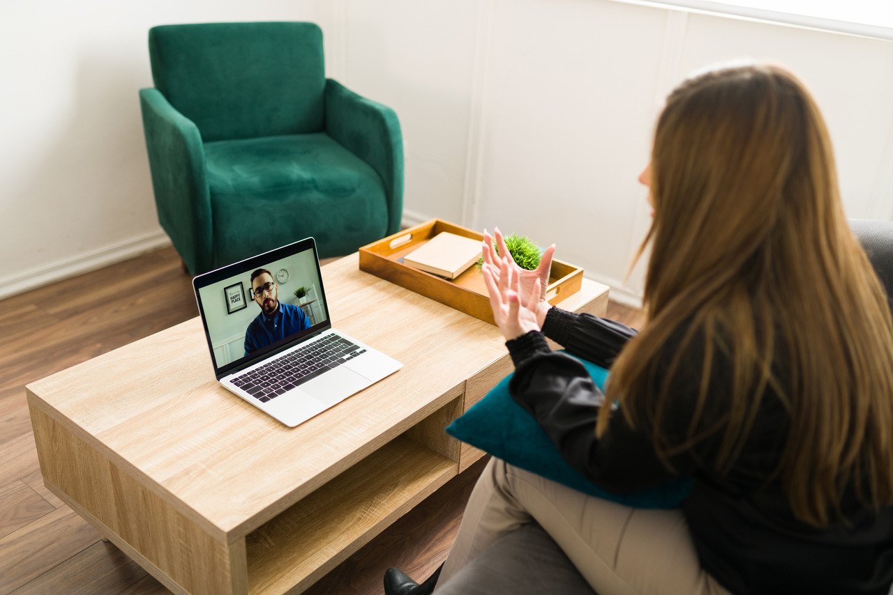 Woman speaking with a virtual therapist using telehealth