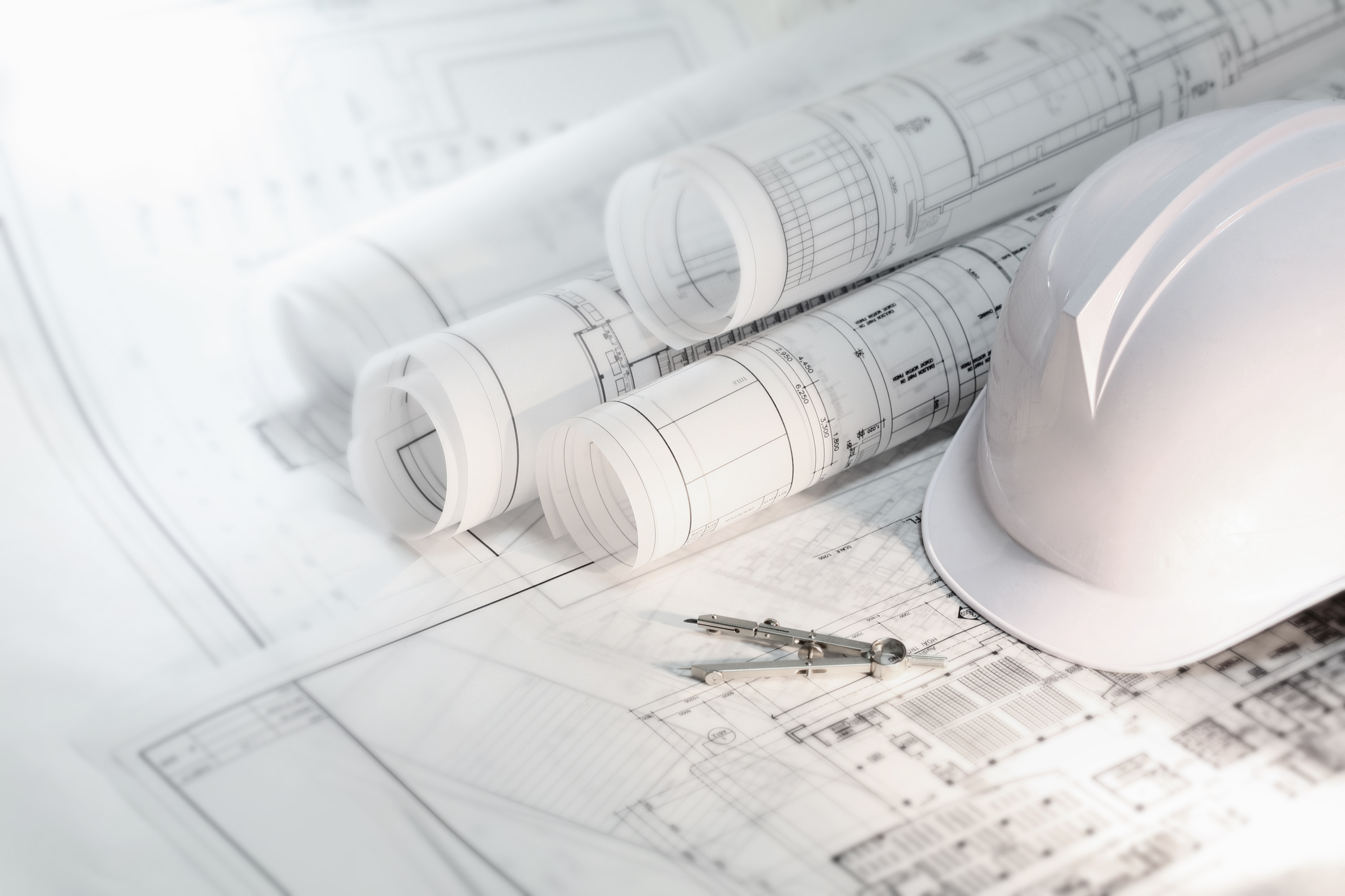 Stock image of blueprints and a hard hat