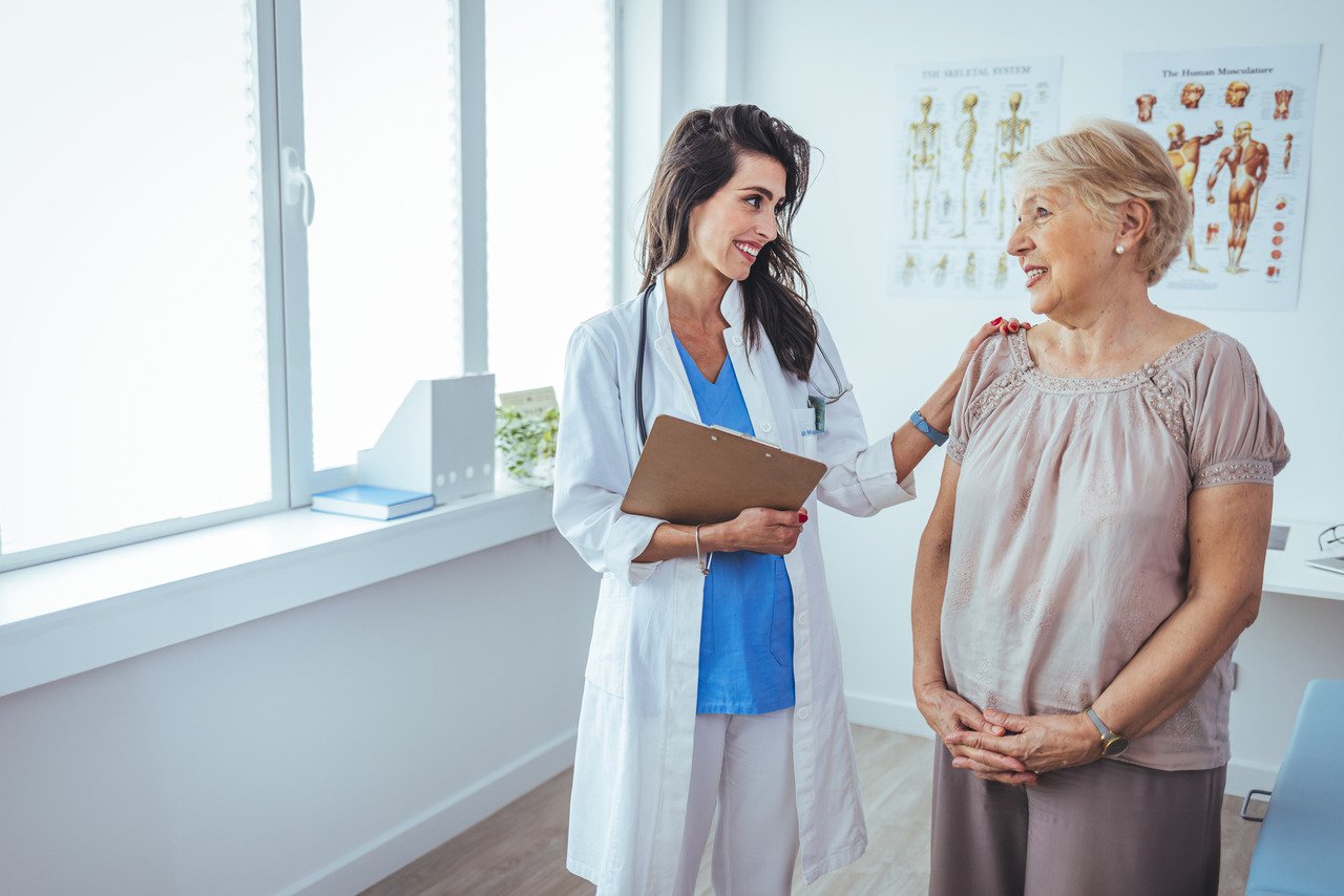 older female patient talking with primary care doctor