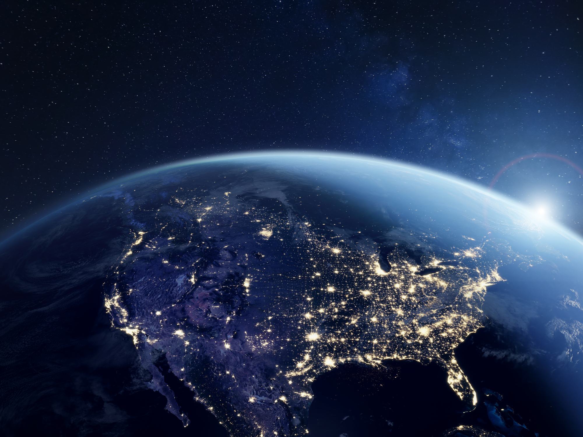 Graphic image of the US from space during the night with lights shining across the country