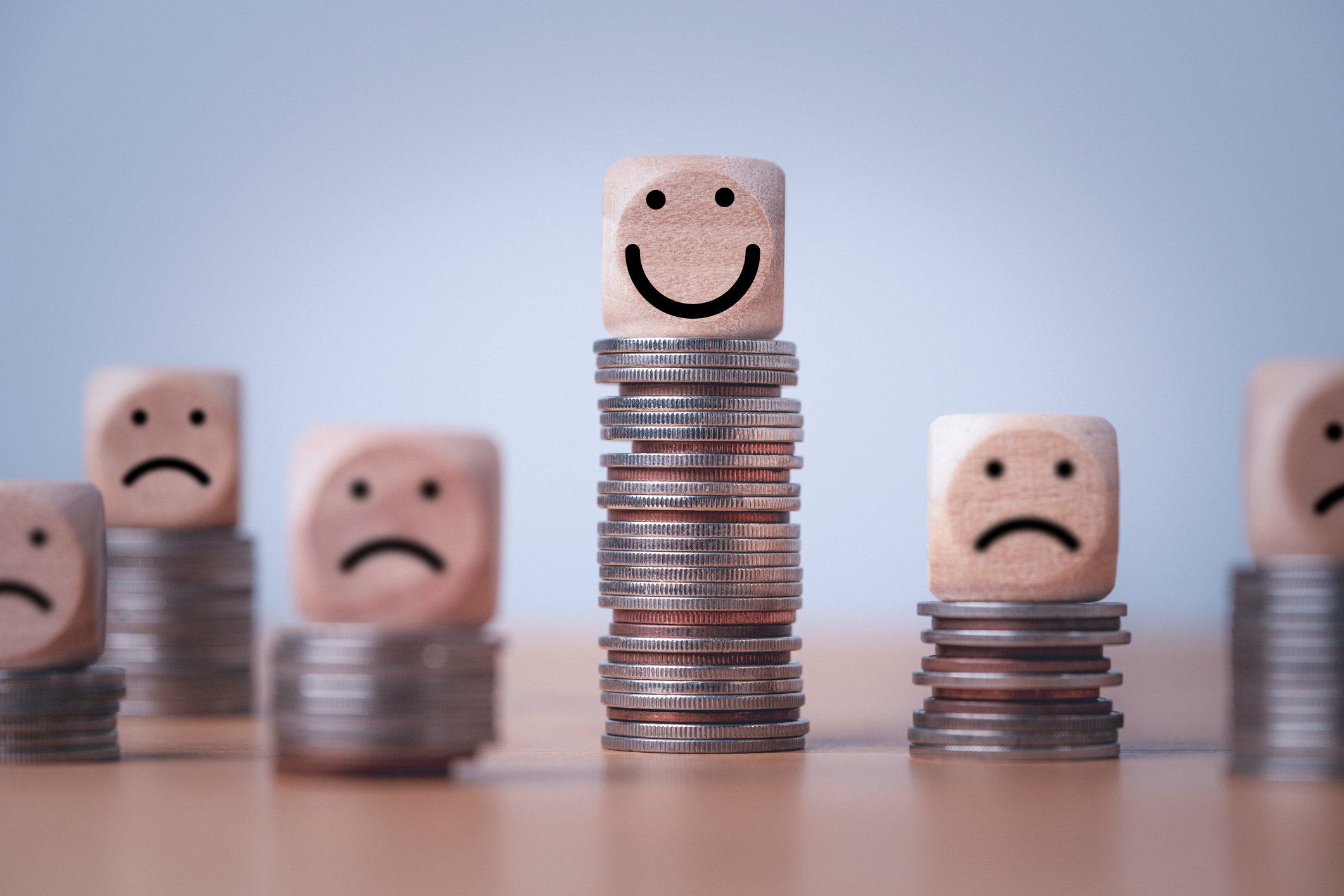 Coin stacking on smiley face and sad face