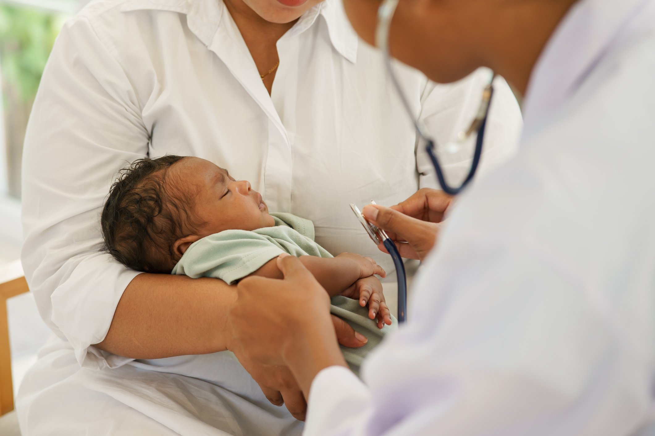 A newborn baby boy with mother visiting the doctor for checkup health with stethoscope at the clinic