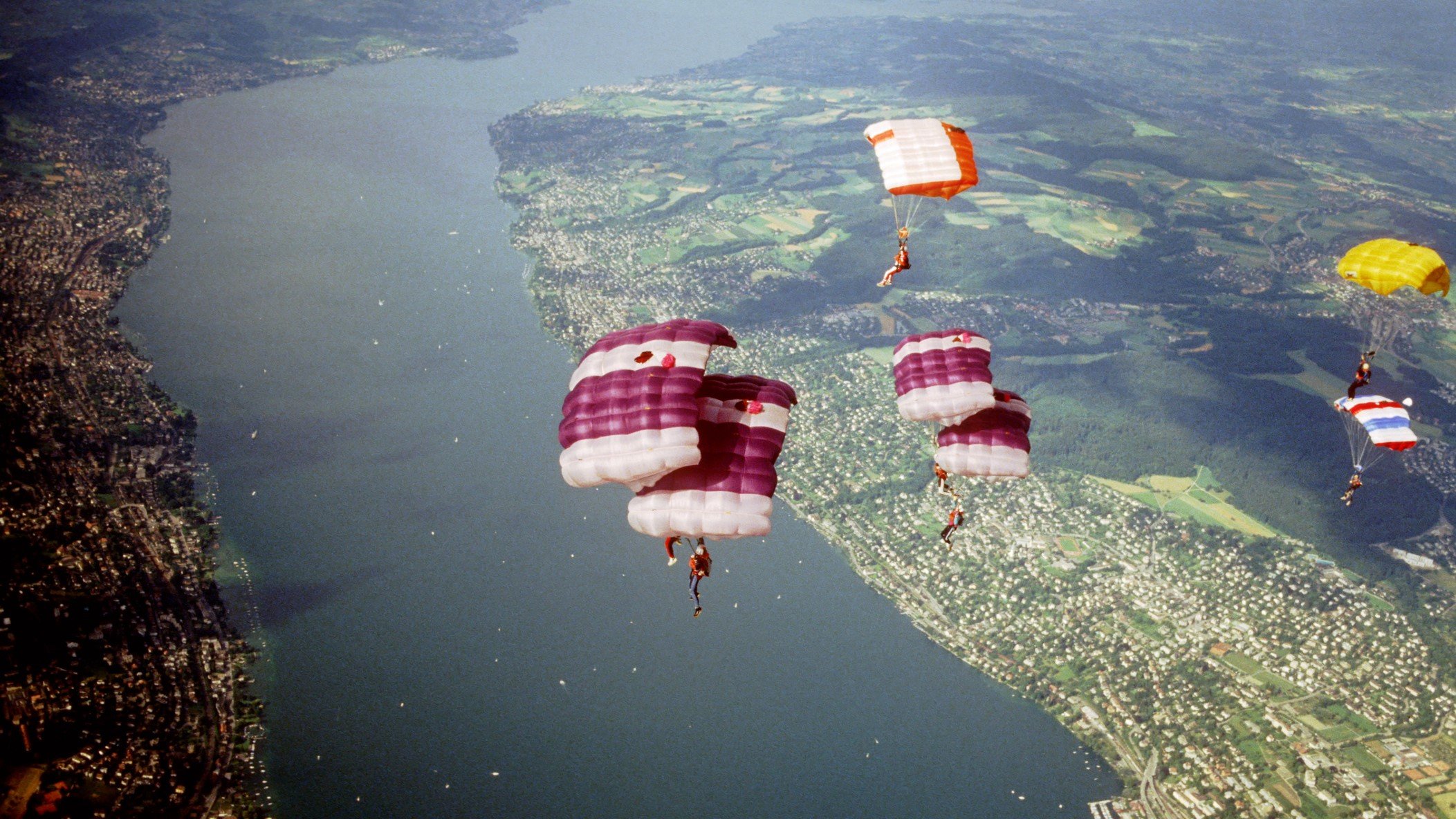 photo of parachutes over a river