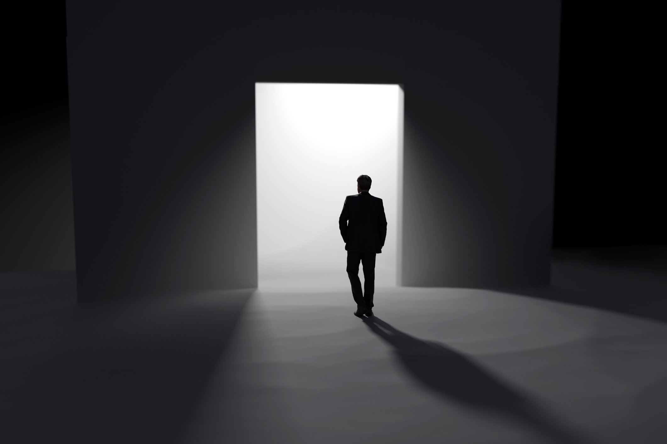 Graphic of a masculine figure walking out of an exit light pouring out