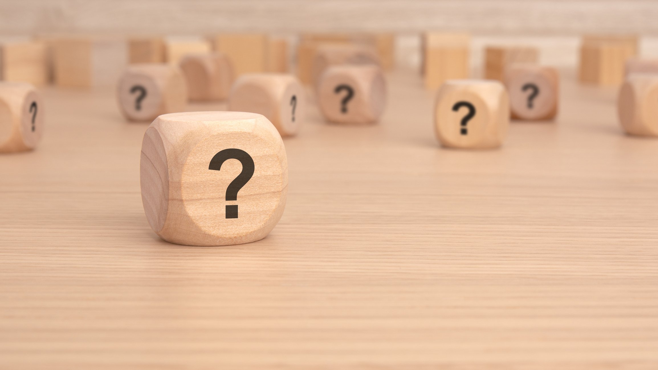 Bunch of wooden blocks with question marks on them