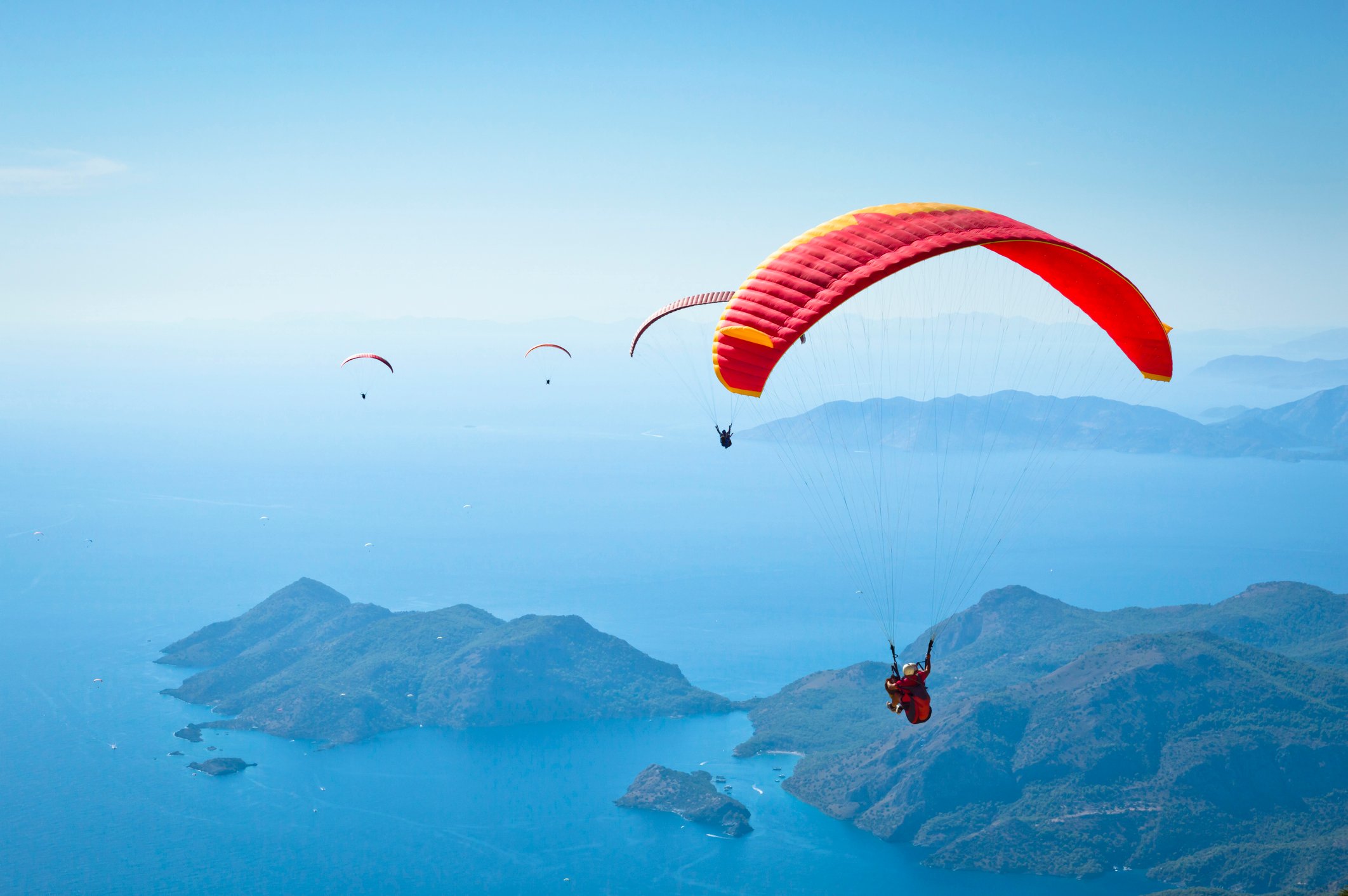 image of a few paragliders