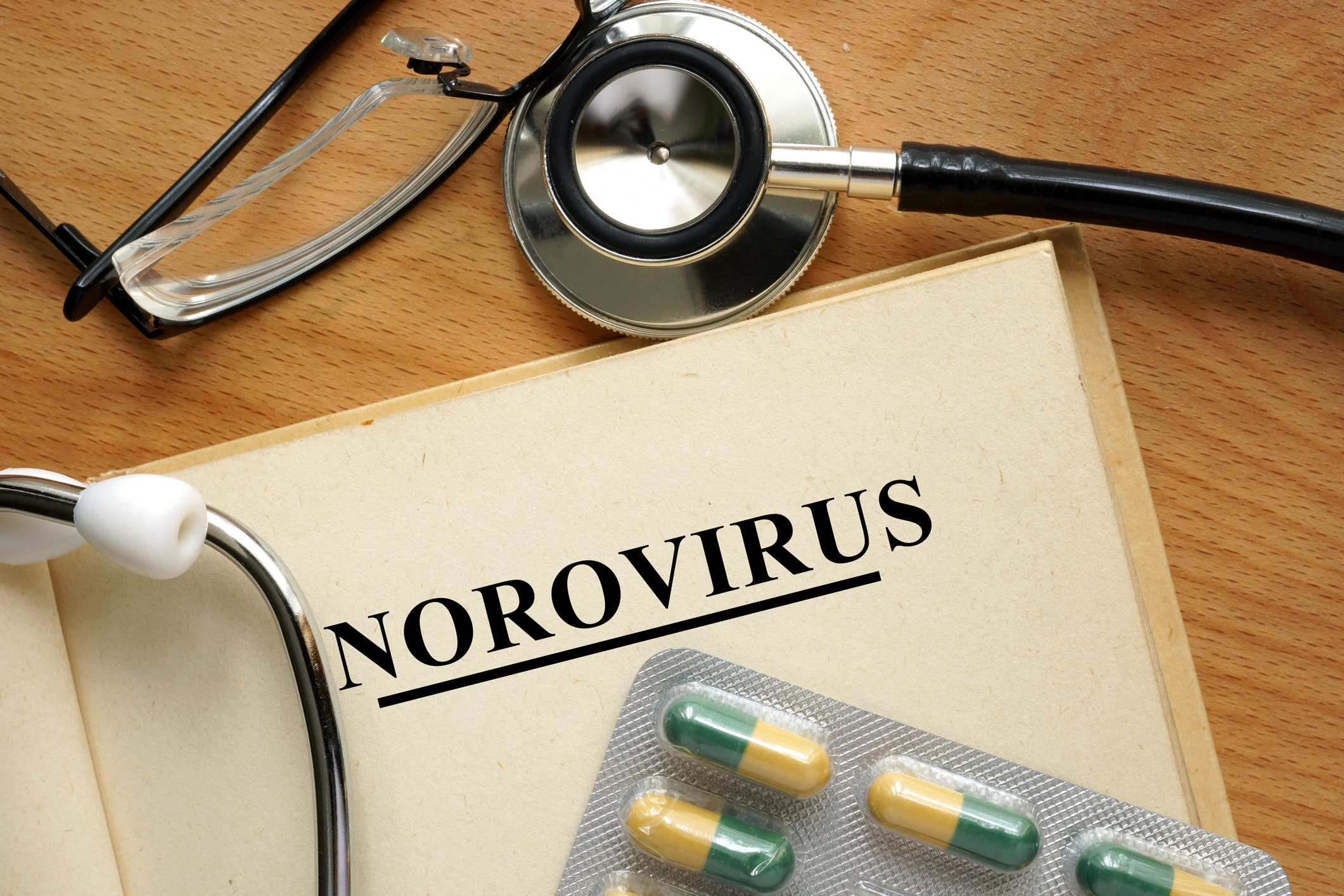 Stock imagegraphic of a page titled Norovirus with a stethoscope and oral pills in the frame