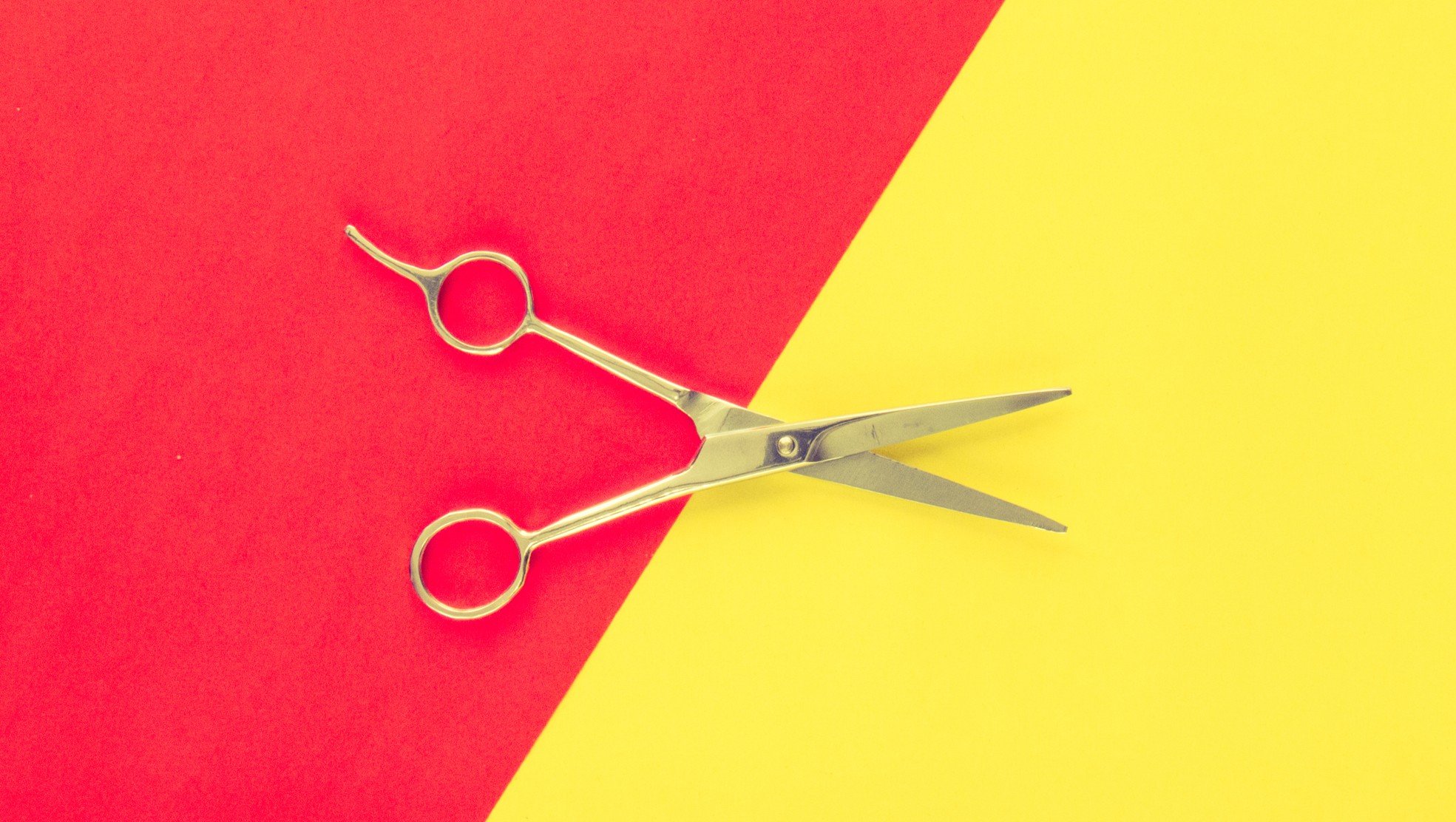 red and yellow background with scissors