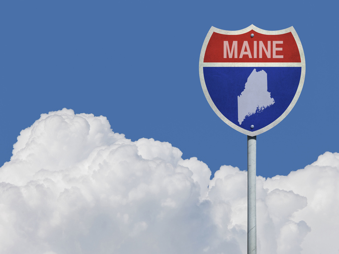 A sign reading Maine with an outline of the state