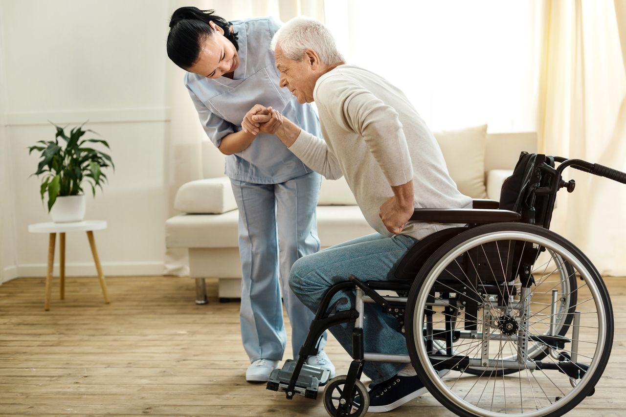 home caregiver providing care to patient in wheelchair