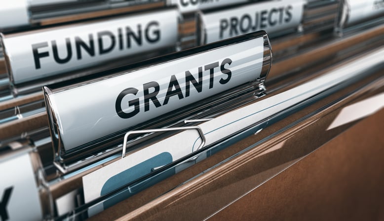 File folders labeled GRANTS FUNDING and RESEARCH