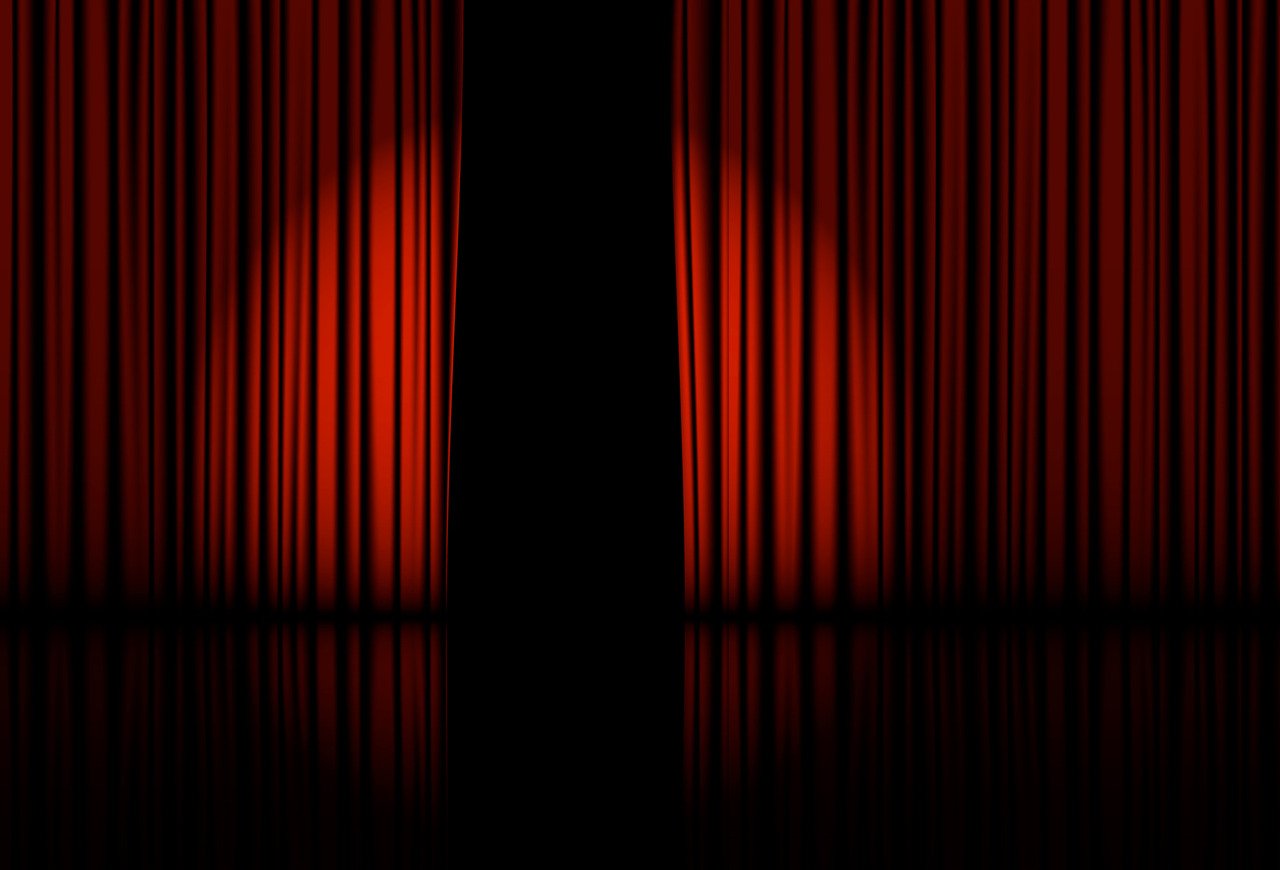 theater stage with red curtain and spotlight