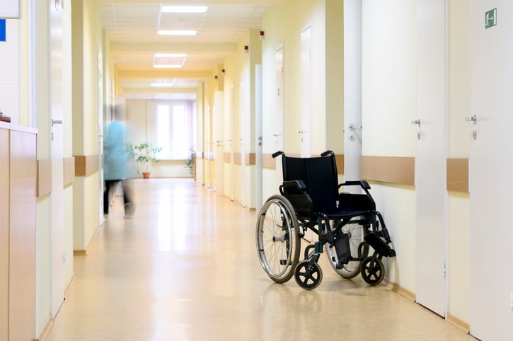 A hallway in a nursing home with a wheelchair