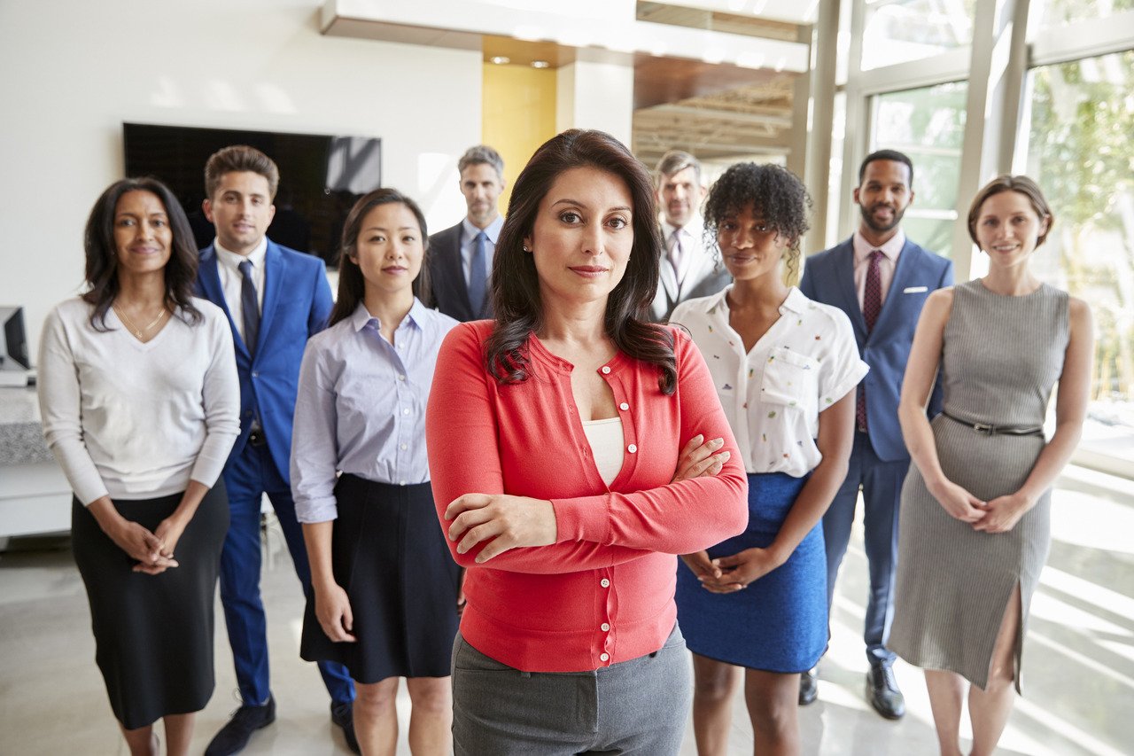 female executive standing with business team