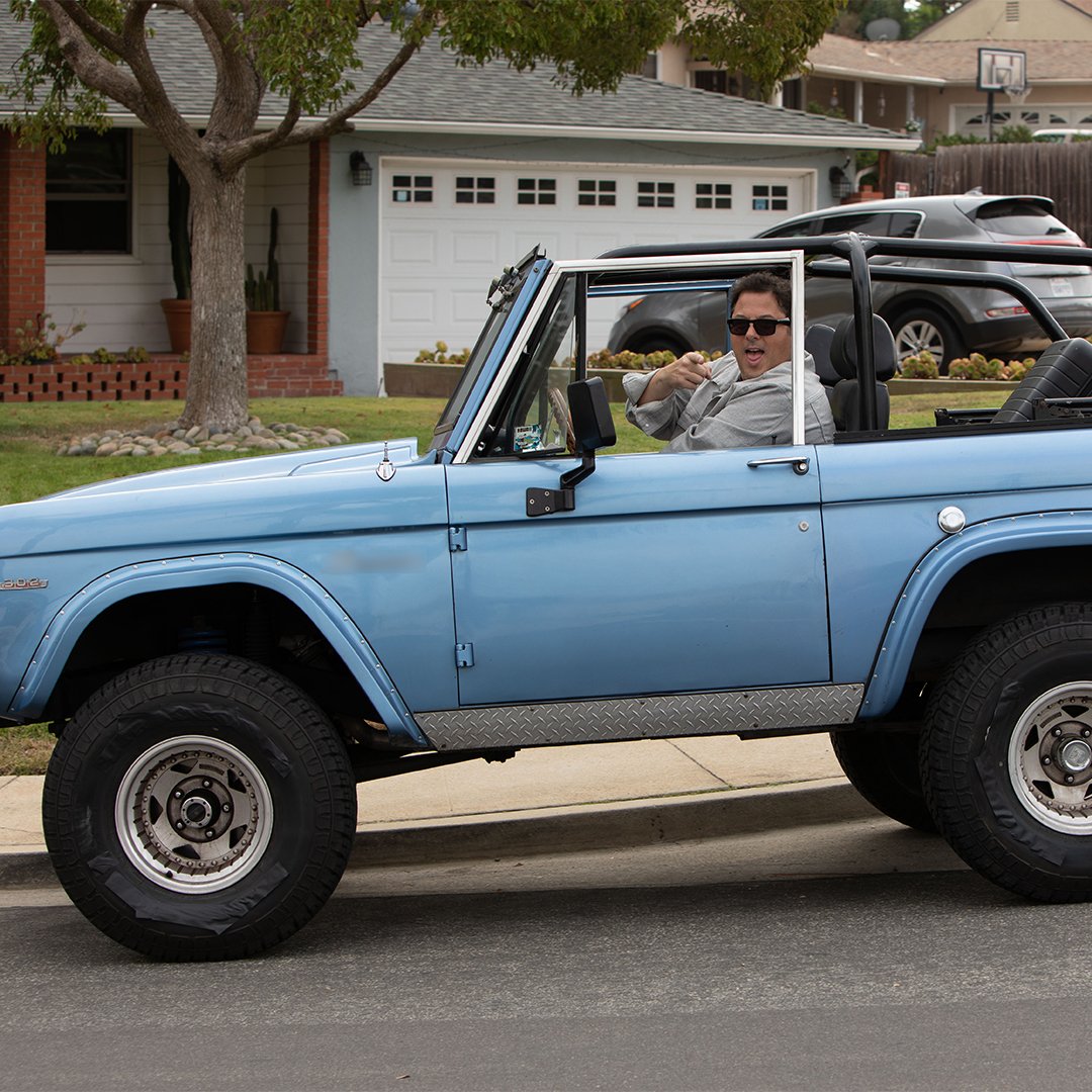 Man in blue jeep