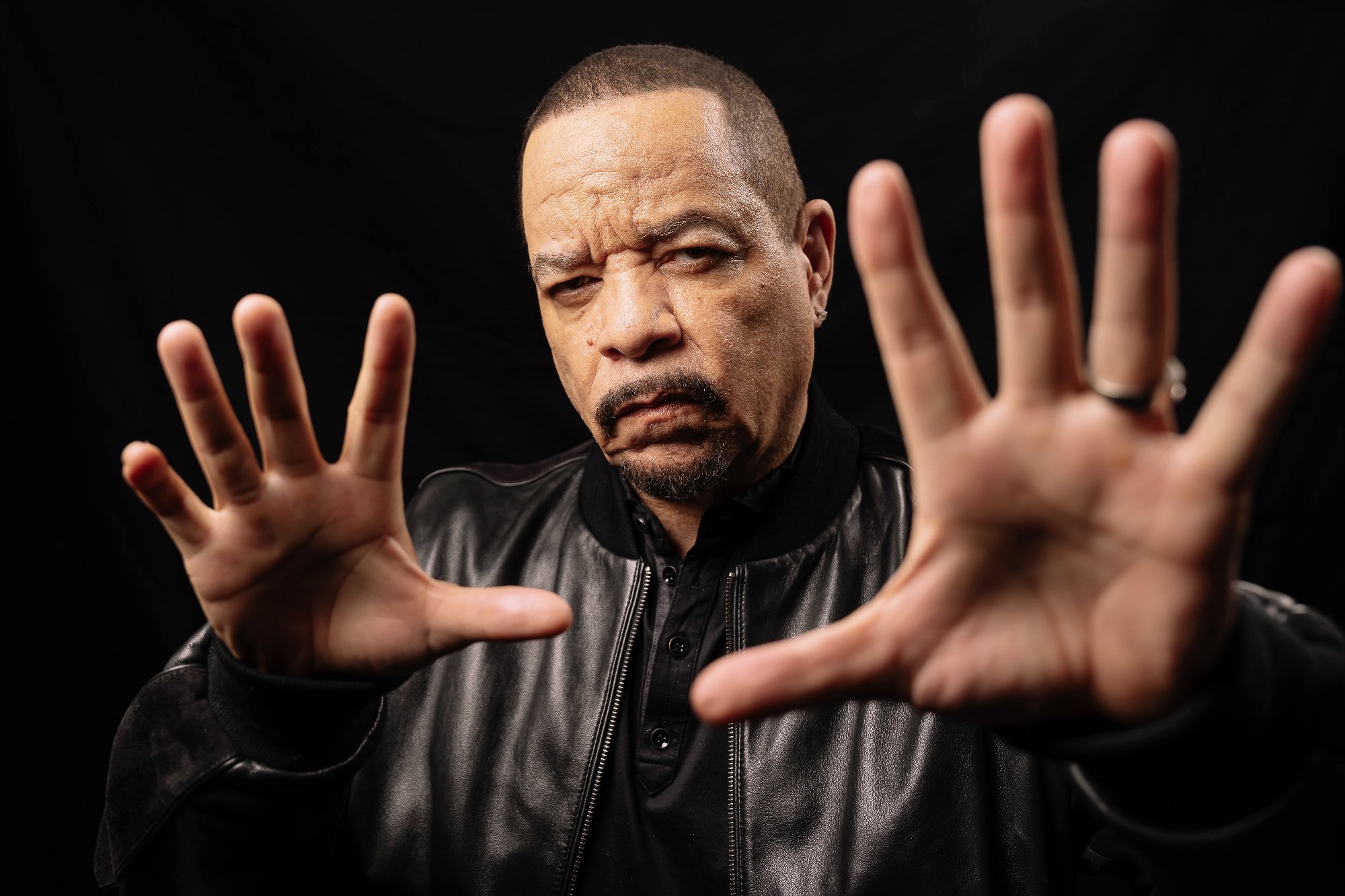 A photo of Ice-T holding out his hands