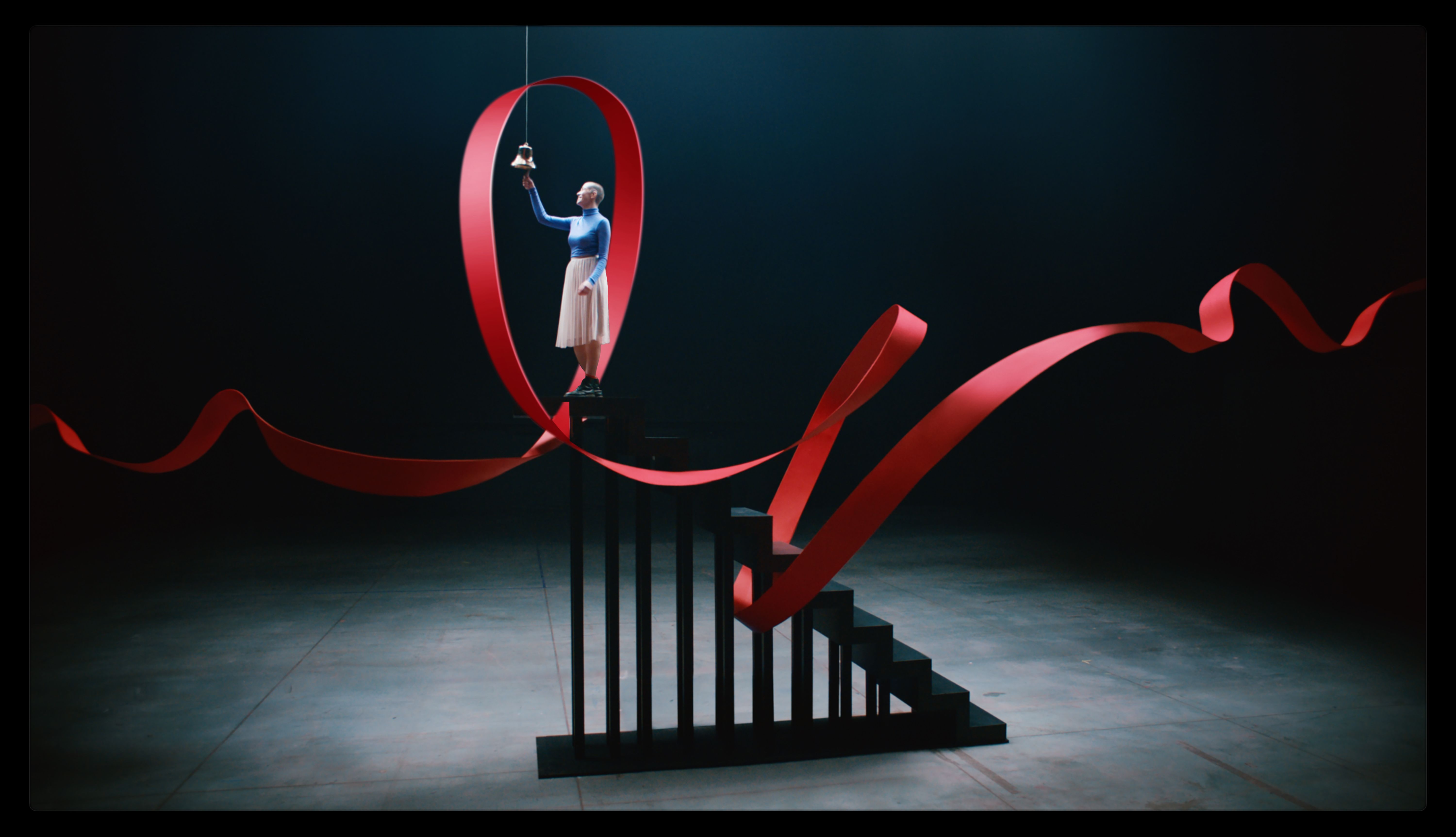 woman on staircase ringing a bell with a red mRNA strand around her