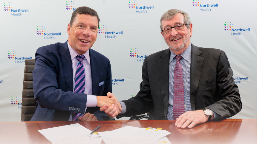 The heads of Nuvance Health and Northwell Health shake hands