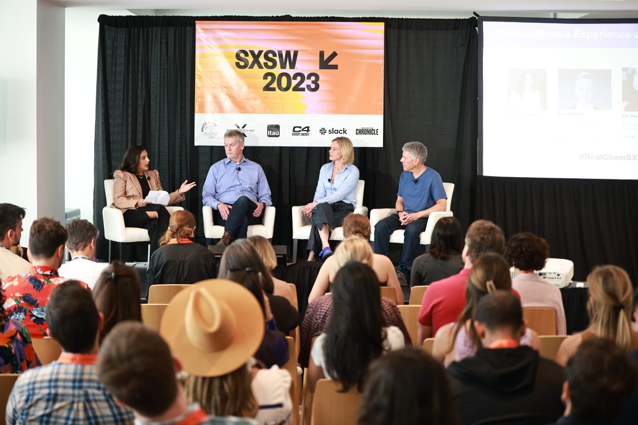 Four healthcare executives sit on a stage during a SXSW panel discussion