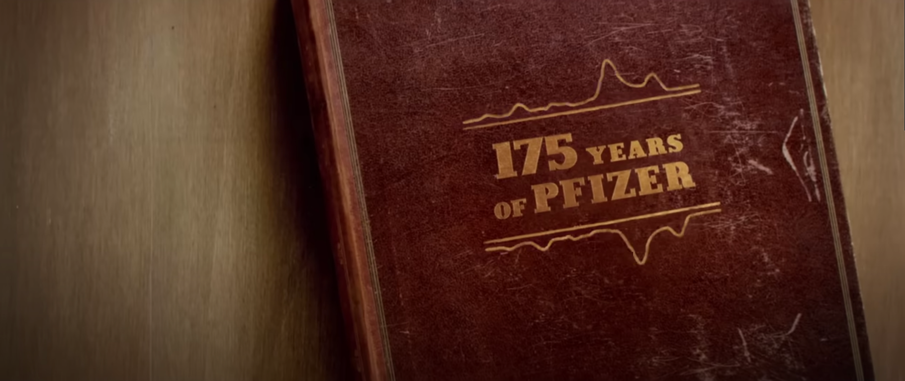 A shot from Pfizers Super Bowl ad showing a book titled 175 Years of Pfizer