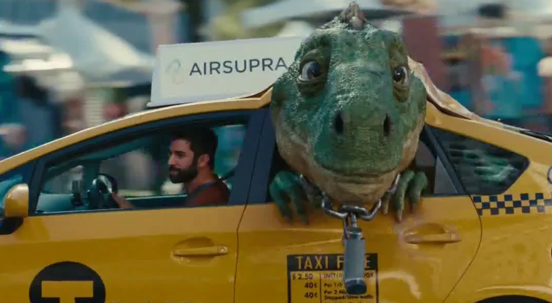 A frame from AstraZenecas Airsupra ad showing a dinosaur in a taxi
