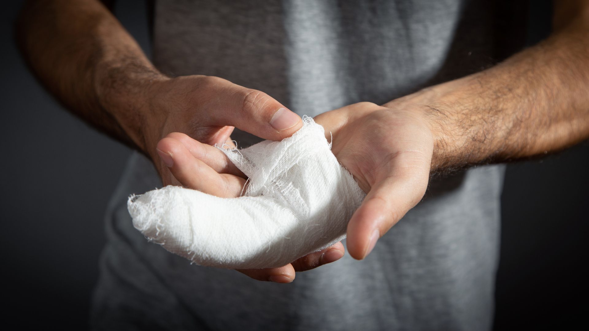 Man with bandage in injured hand