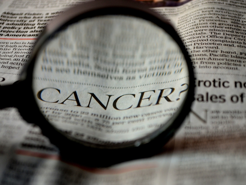 Cancer in newspaper clipping