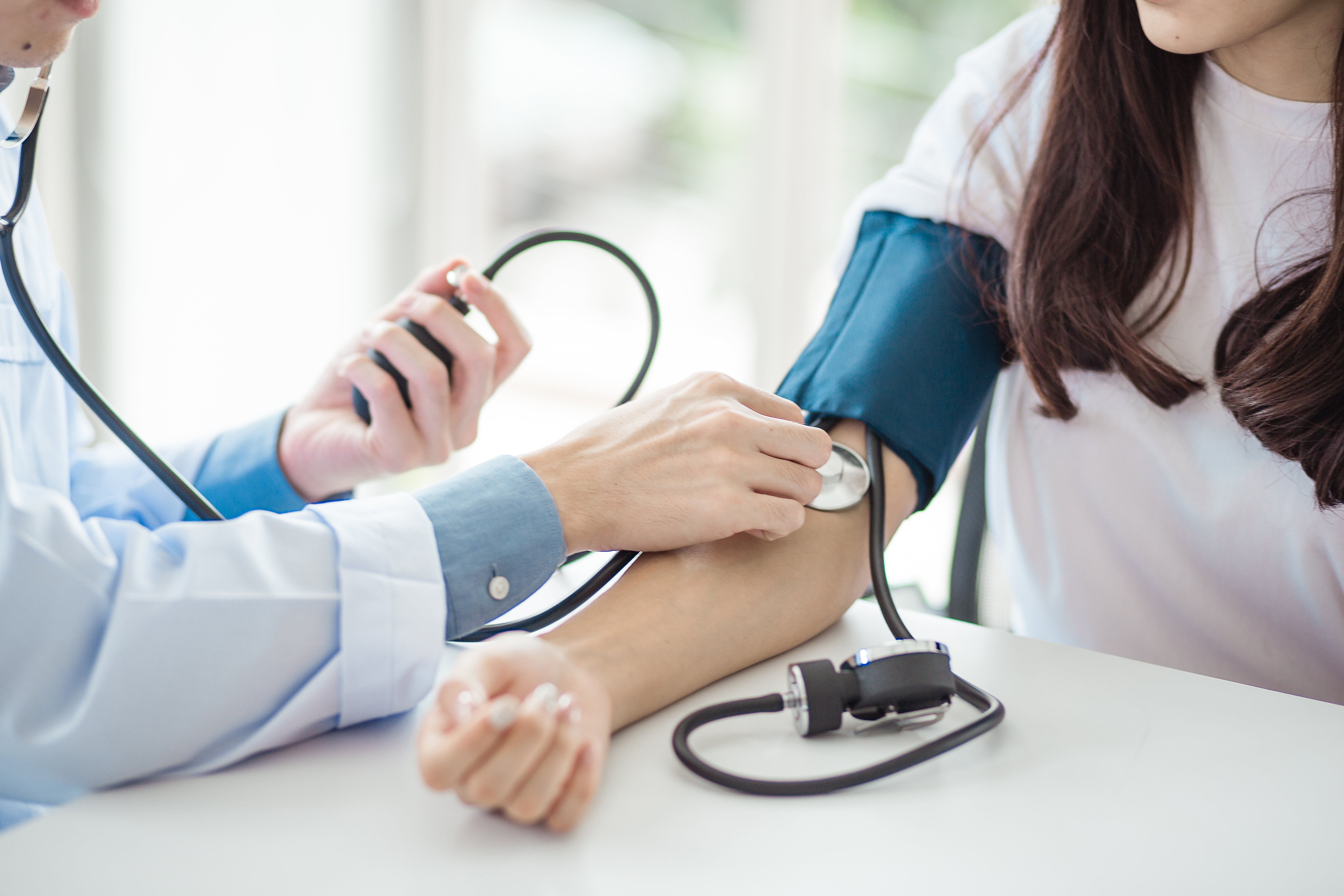 A doctor checking a patients blood pressure