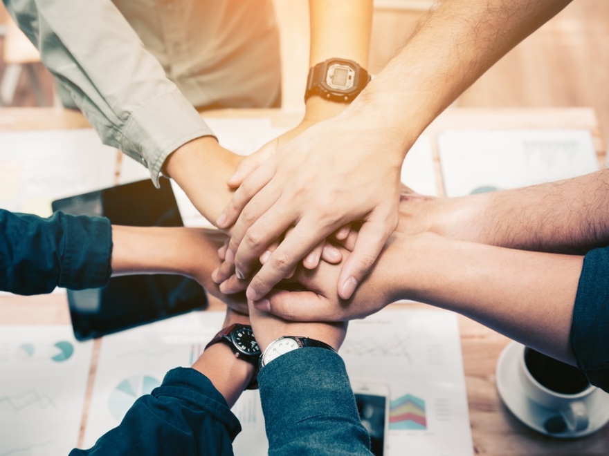 Group joining hands - collaboration iStockPhoto