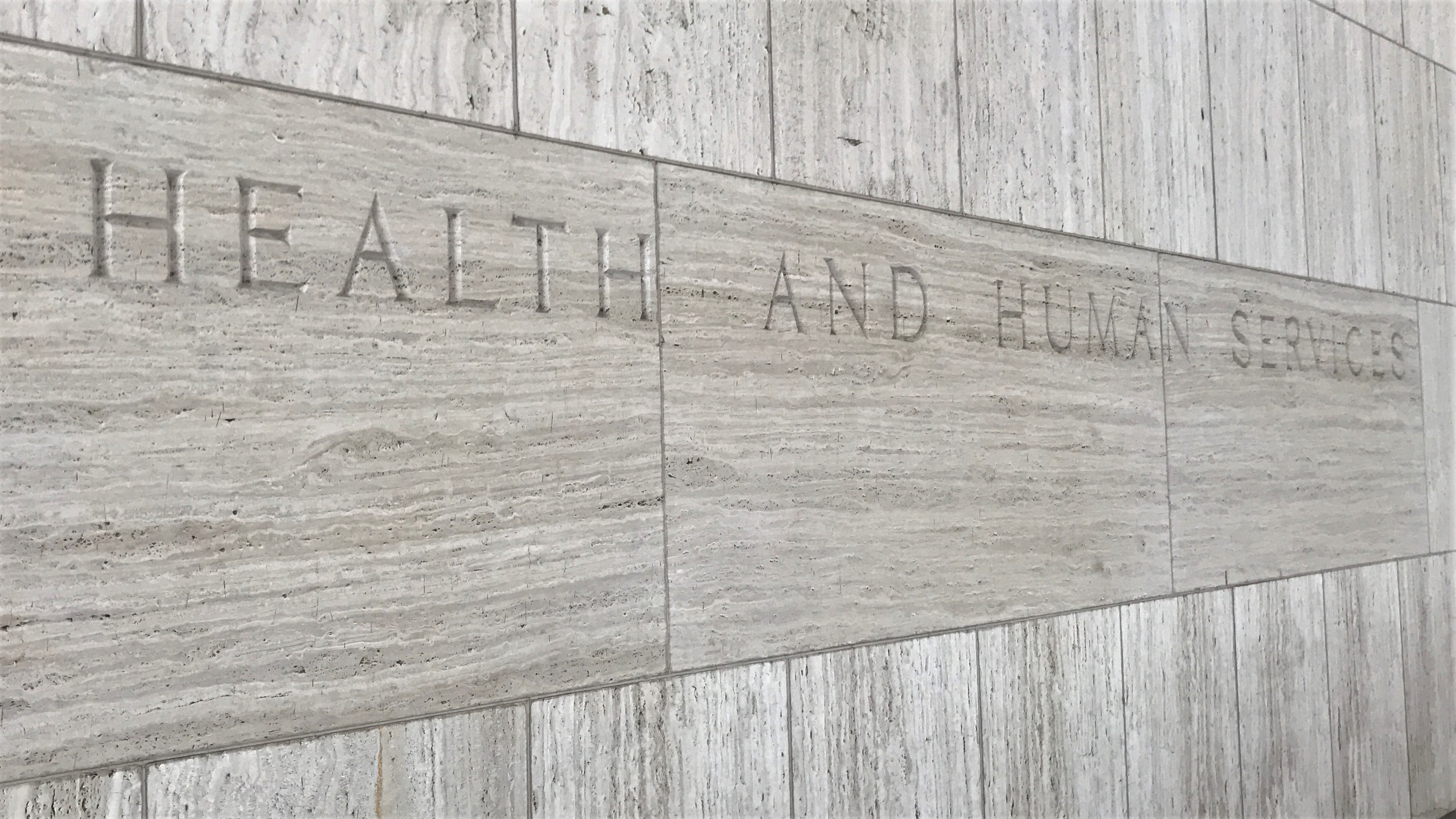 Marble exterior of the Hubert H Humphrey Building in Washington DC Text on building reads Department of Health and Human