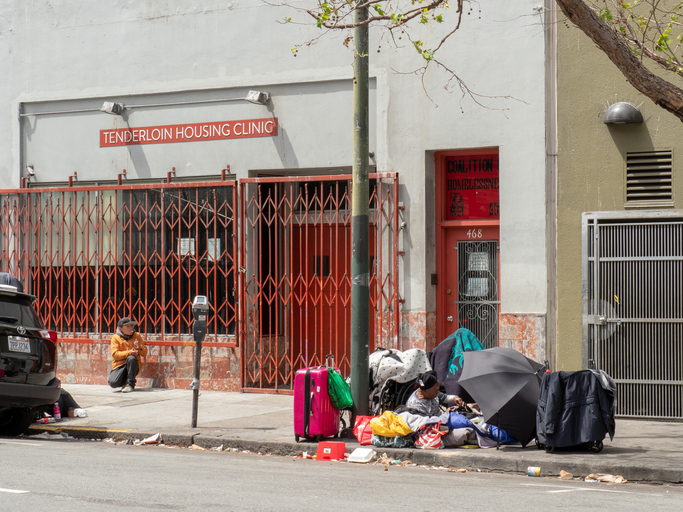 Homeless individuals line up outside Tenderloin Housing Clinic in San Francisco 