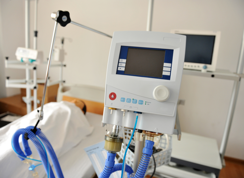 medical equipment in hospital room next to patient bed
