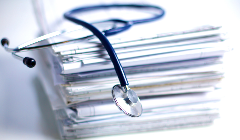 close up of paper files with stethoscope laying on top