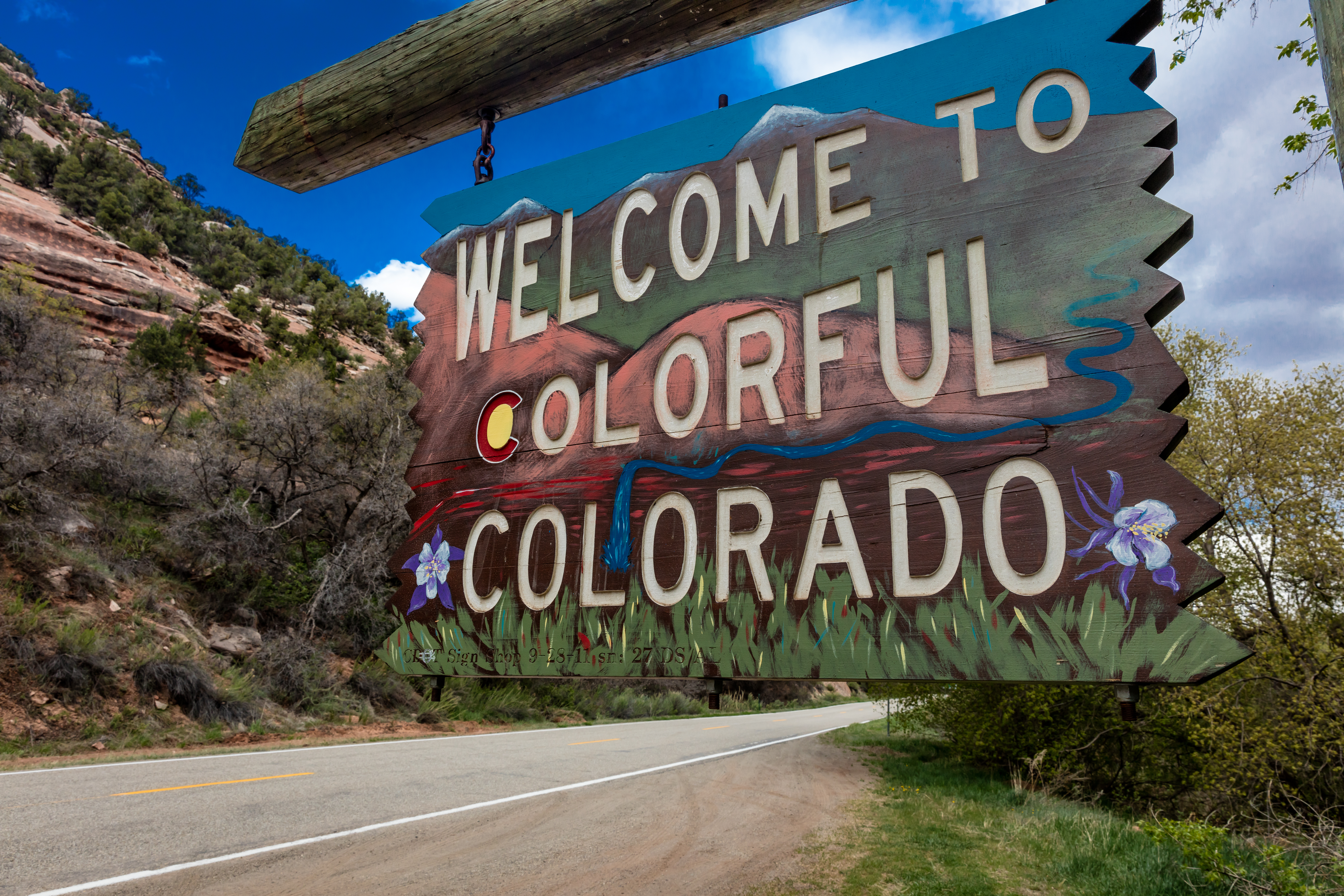 A wooden sign that reads Welcome to colorful Colorado
