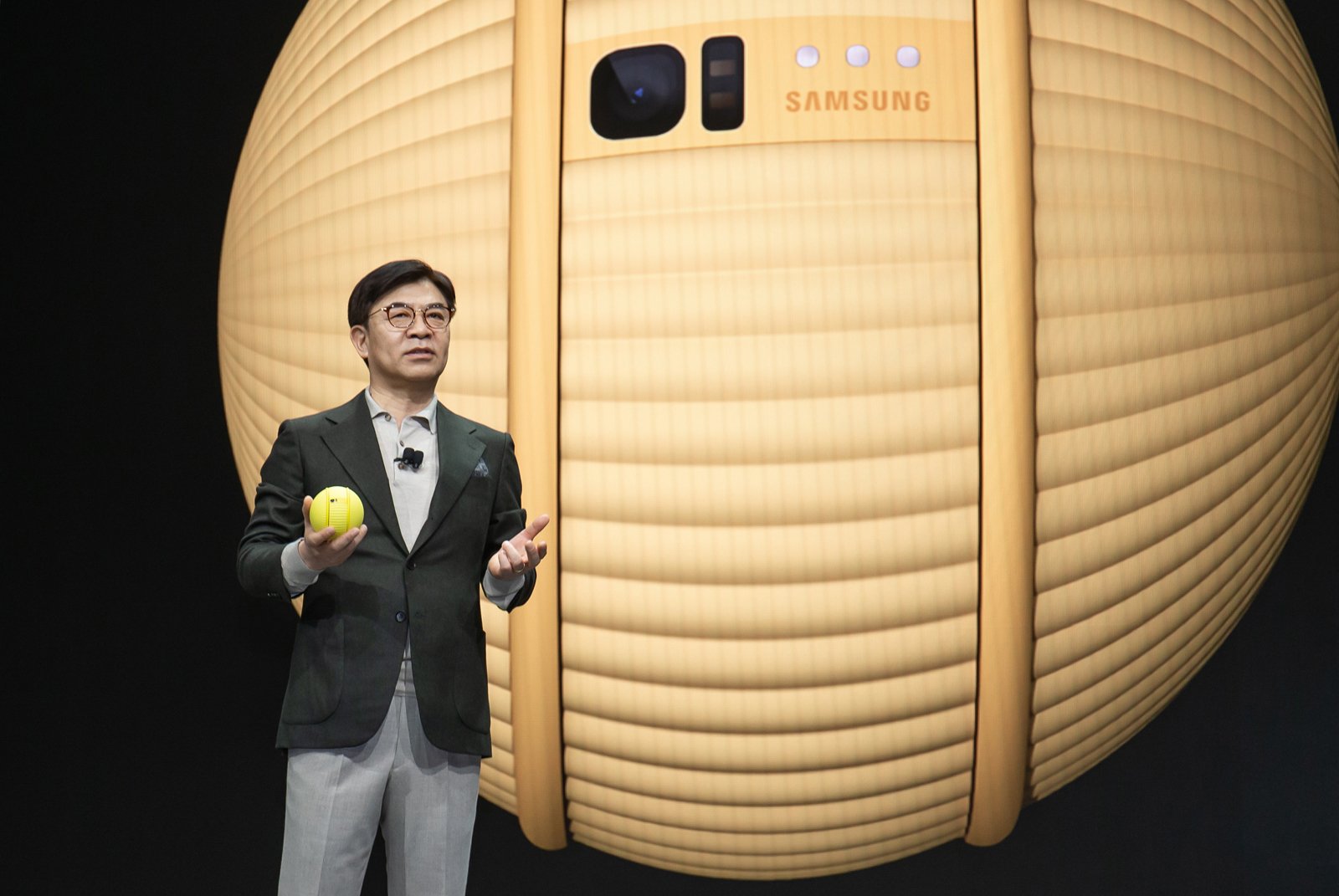 Samsung CEO and president Hyun-Suk Kim standing on a stage speaking at CES 2020 conference