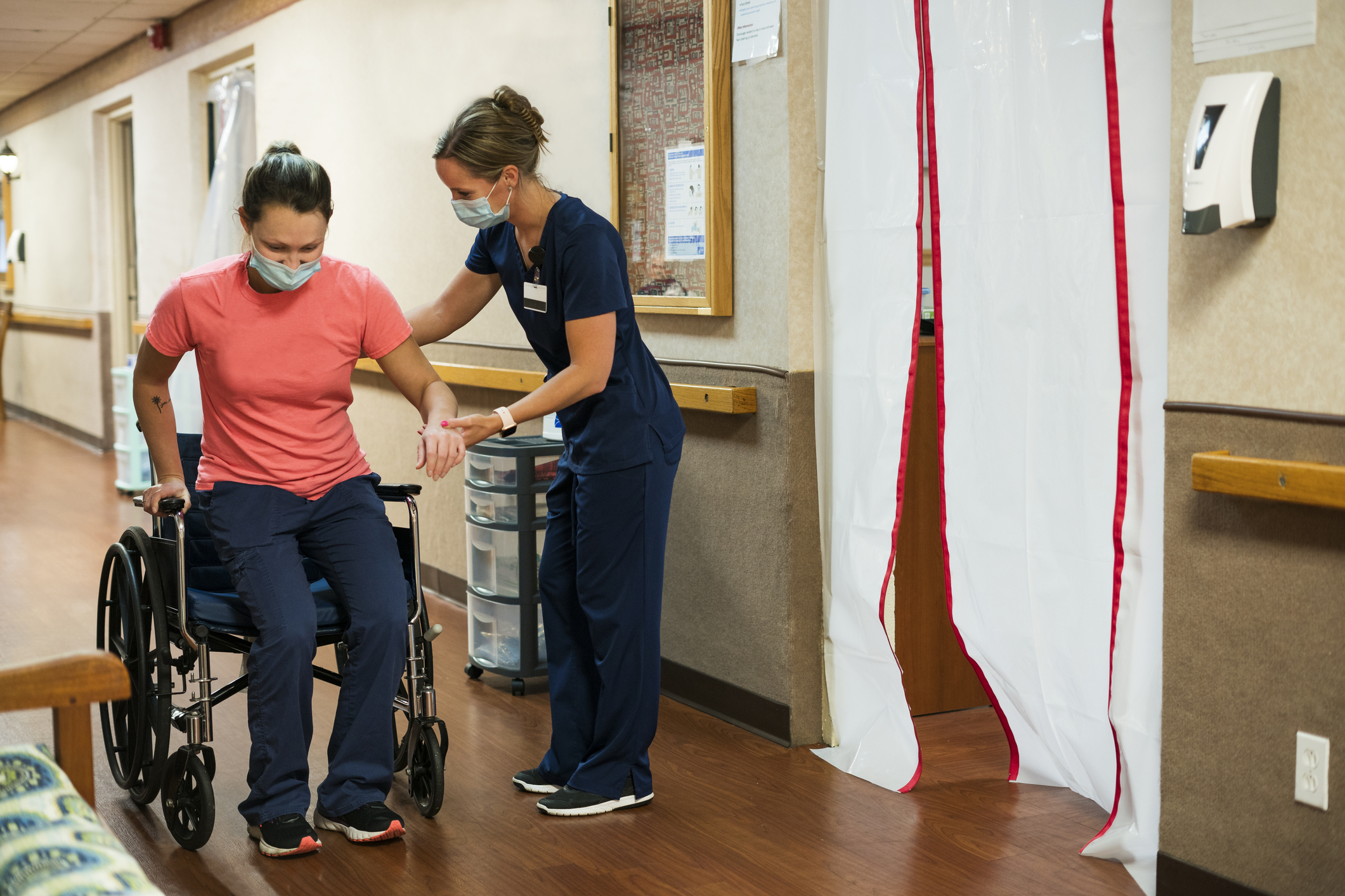 Nurse helps a patient in a wheelchair