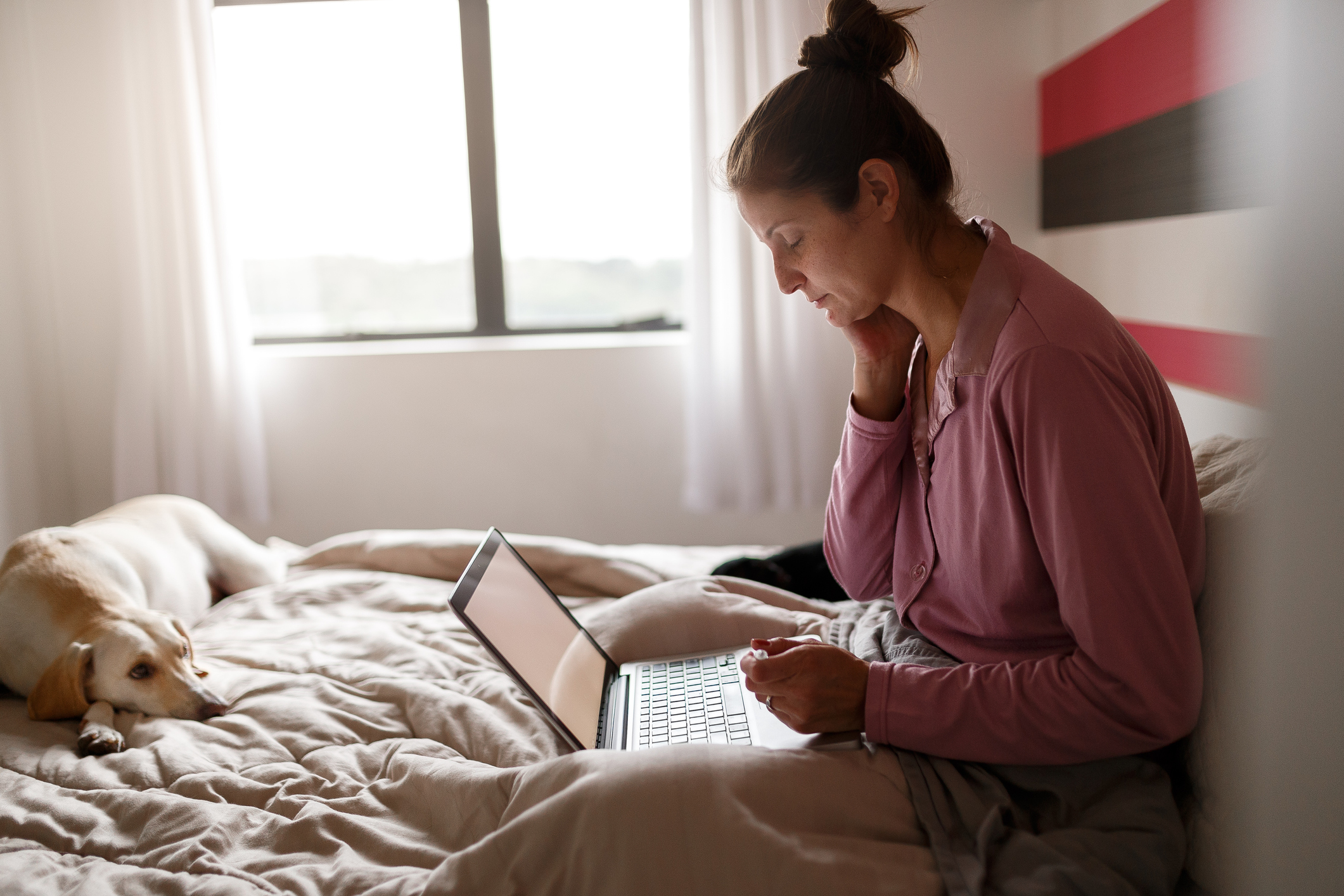 Person using computer in bed