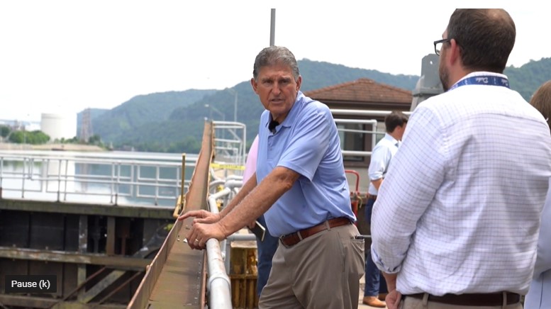 Manchin at a dam for infrastructure package