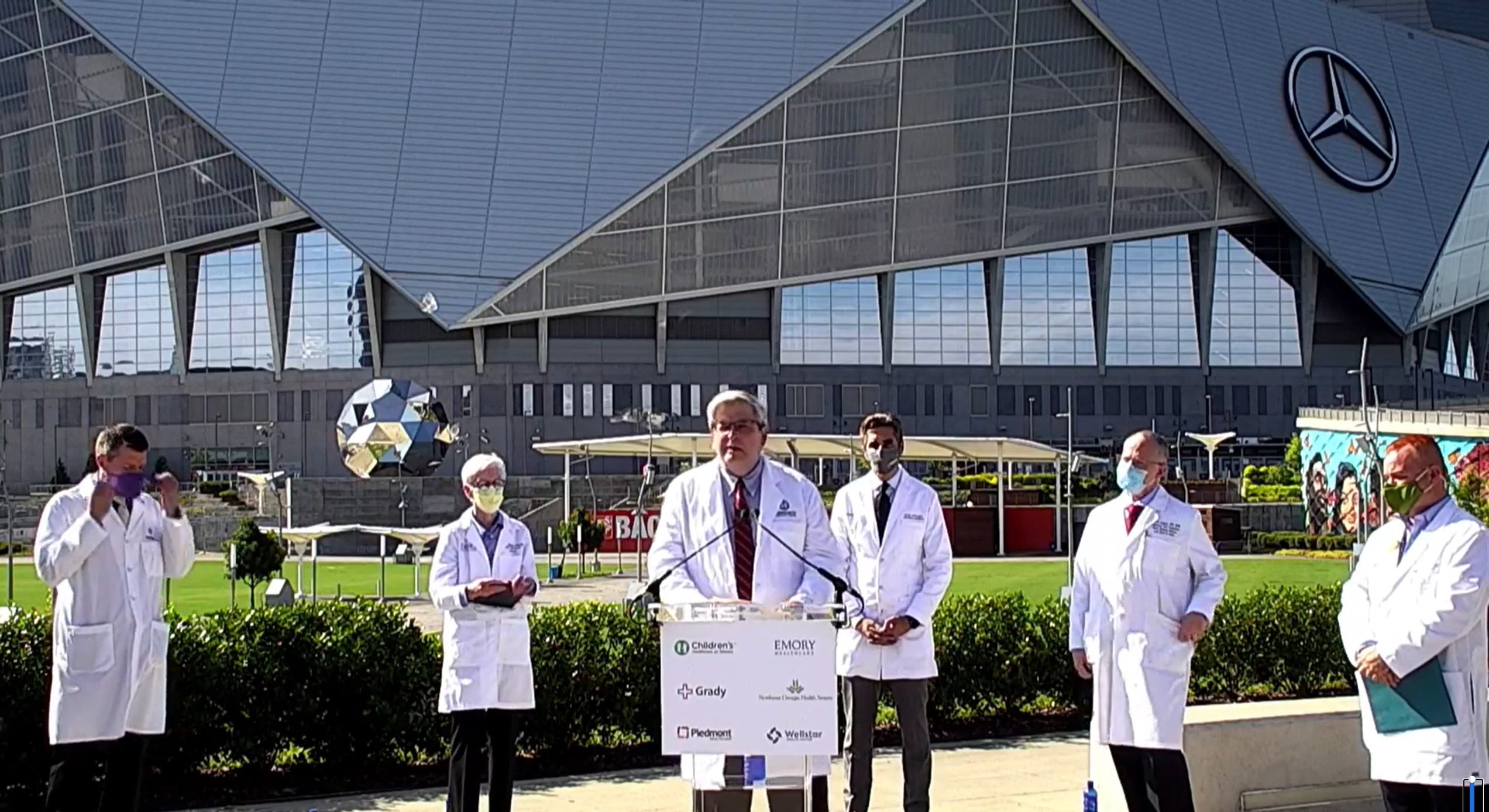 Atlanta clinical leaders address the press in front of Mercedes-Benz Arena in August 2021