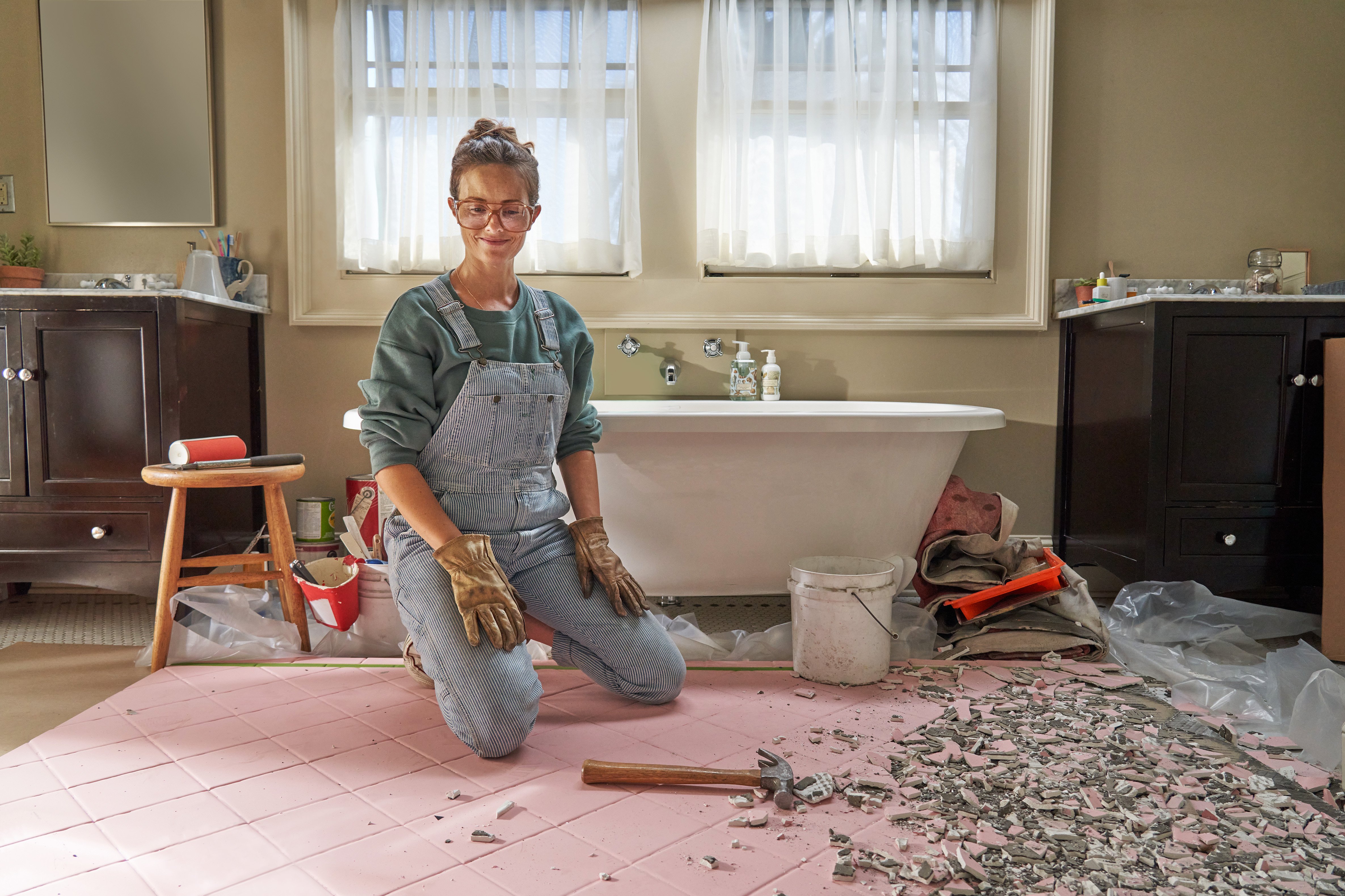 Woman in the middle of a bathroom demolition