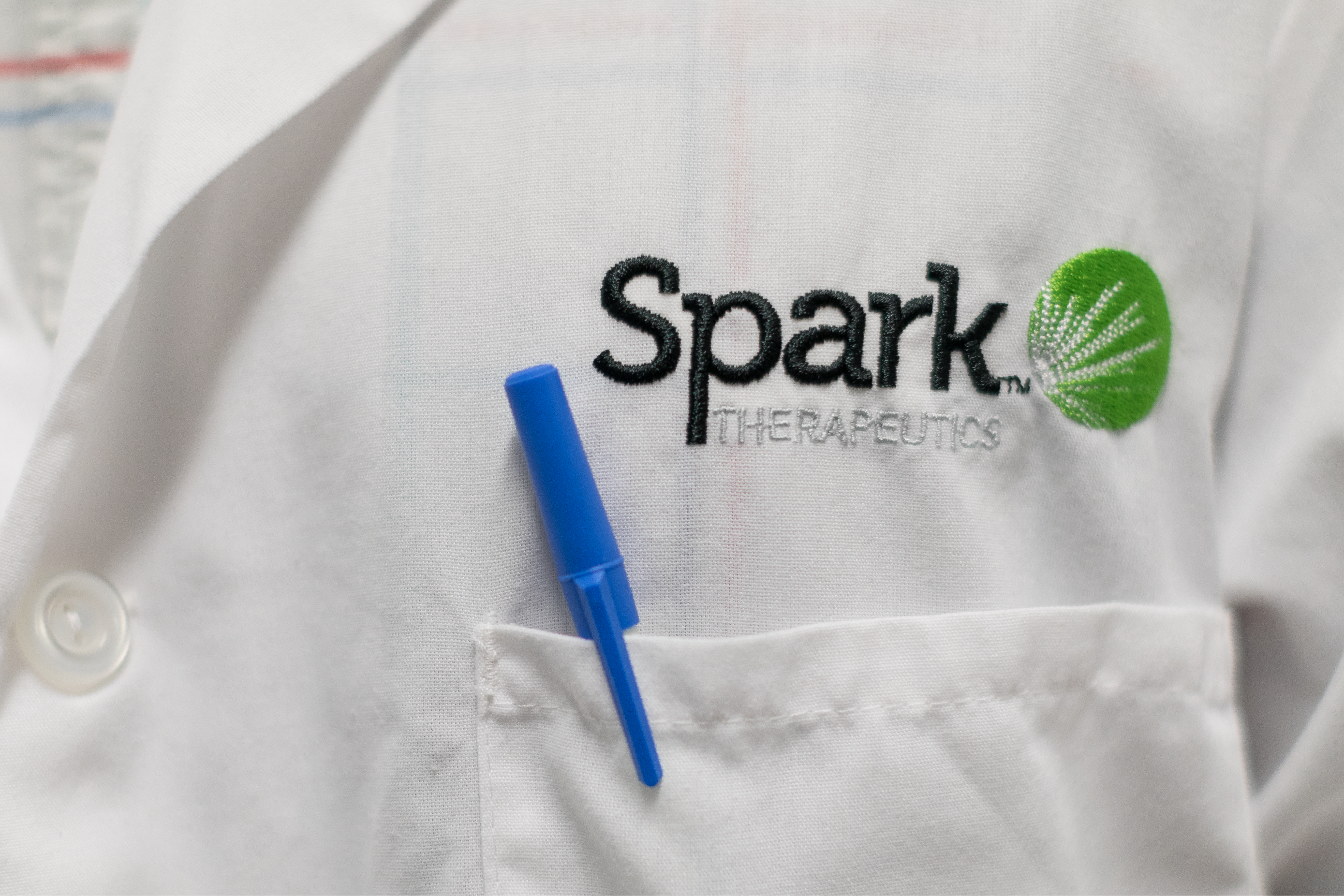 Spark Therapeutics logo on labcoat