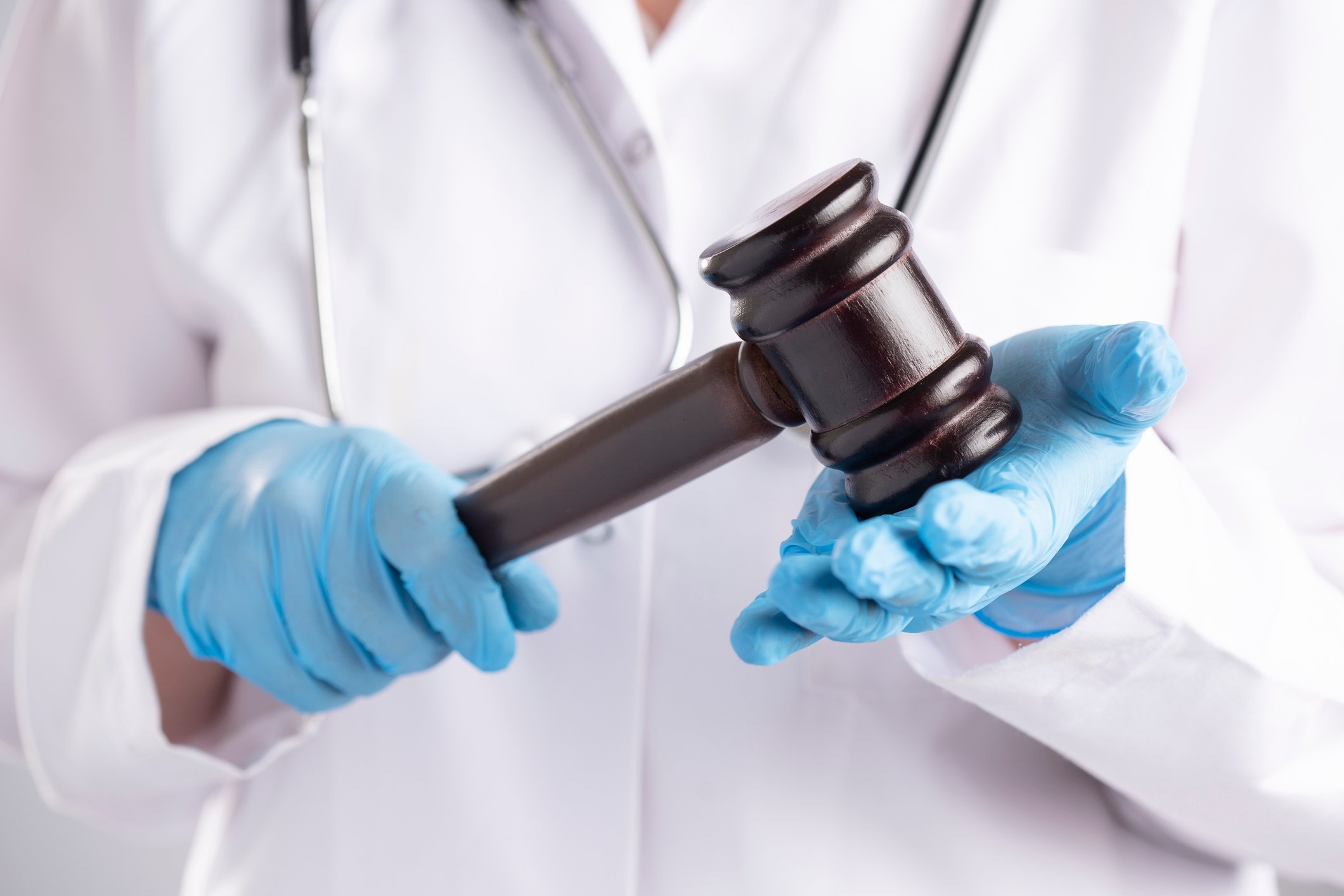A doctor holds a gavel