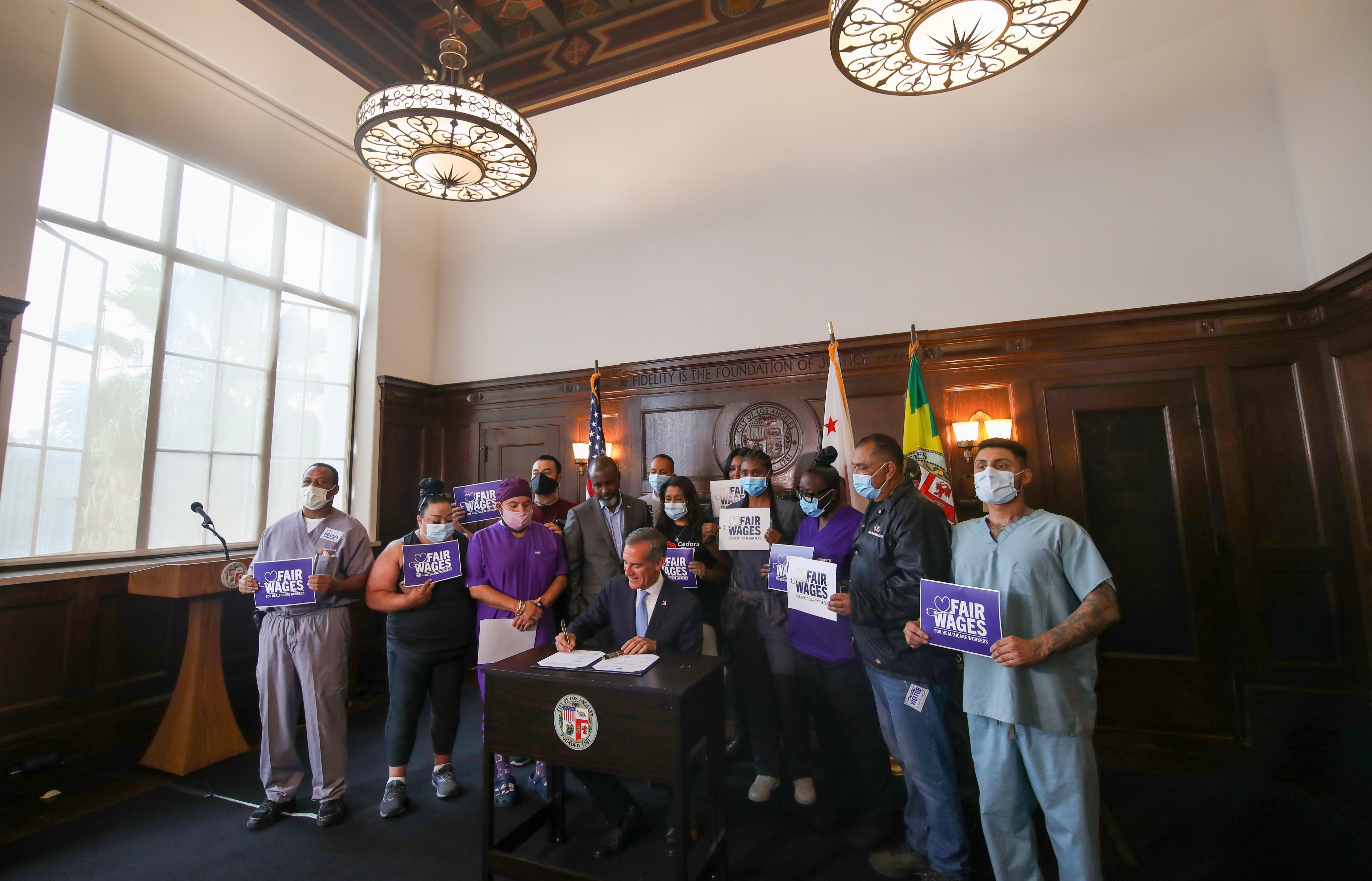 LA Mayor Eric Garcetti signs an ordinance to increase healthcare workers minimum pay