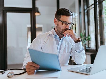 Doctor looking at laptop