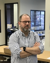 photo of Ron Wince standing in front of desk