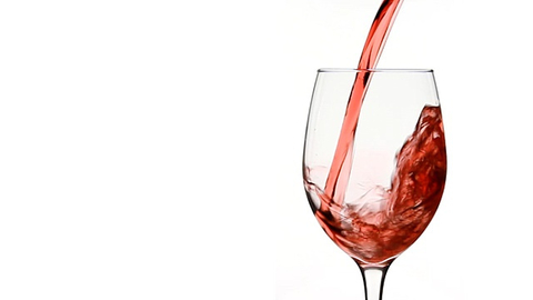 red wine being poured into a glass