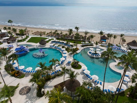 Mexico development with pools, the ocean and palm trees